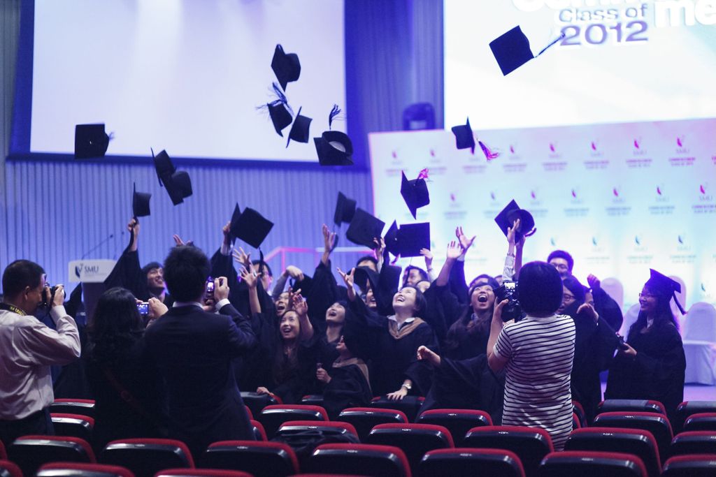 Miniature of Commencement 2012 with students tossing their mortar caps