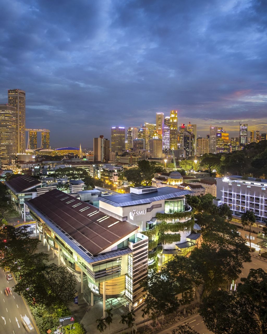 Miniature of Night aerial view of SMU campus building against the backdrop of the financial district of Singapore