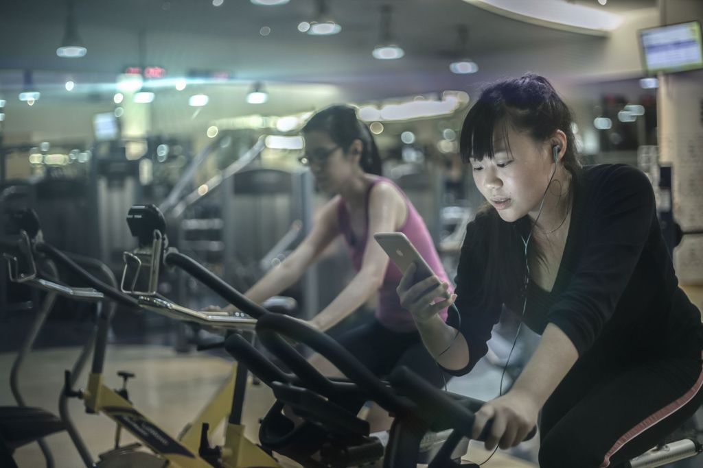 Miniature of Students exercising on the stationary bike in the gymnasium